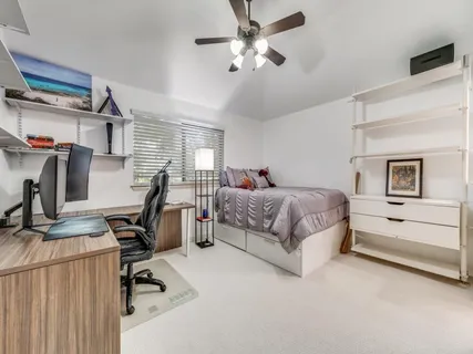 a bedroom with a bed and a desk