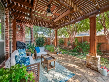a patio with glass windows and outdoor seating