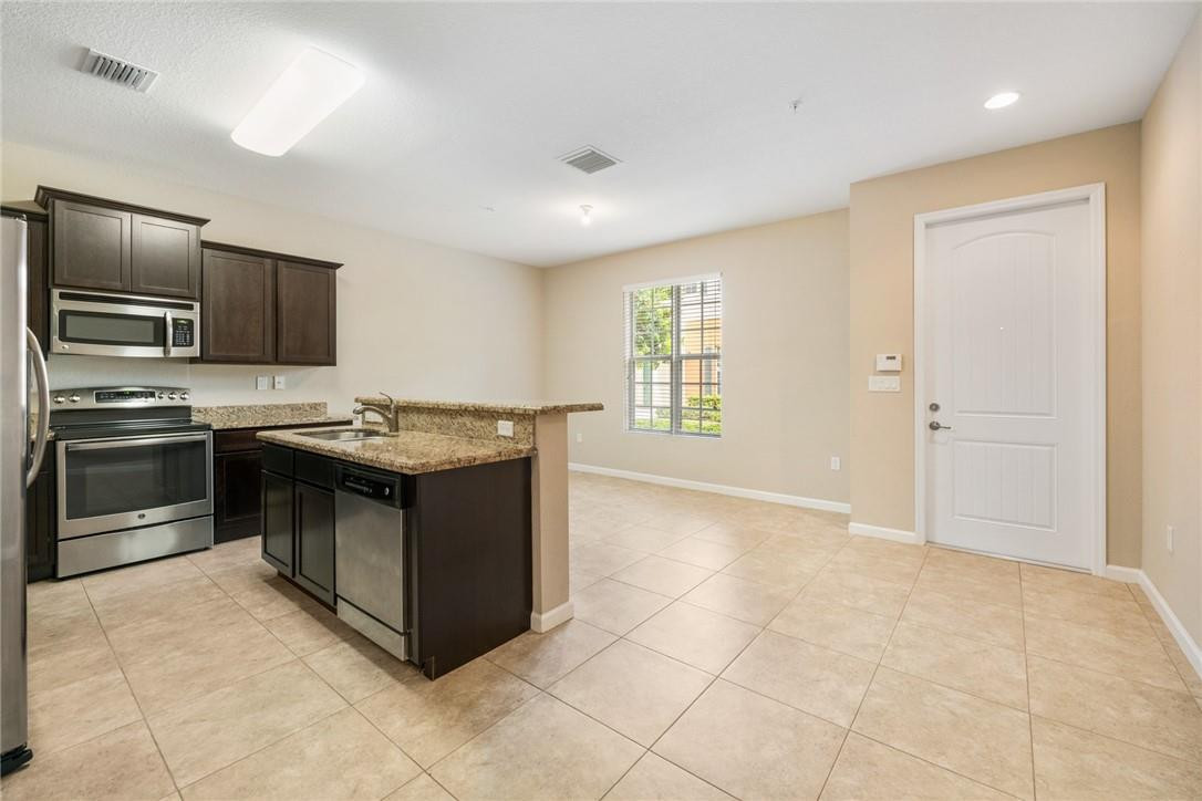 710 Southwest 1st Way Pompano Beach, FL 33060 - Photo 16 of 38 a kitchen with stainless steel appliances granite countertop a stove and a sink
