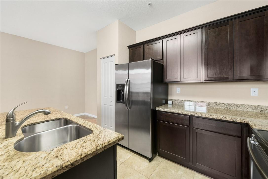 710 Southwest 1st Way Pompano Beach, FL 33060 - Photo 20 of 38 a kitchen with granite countertop a sink and refrigerator