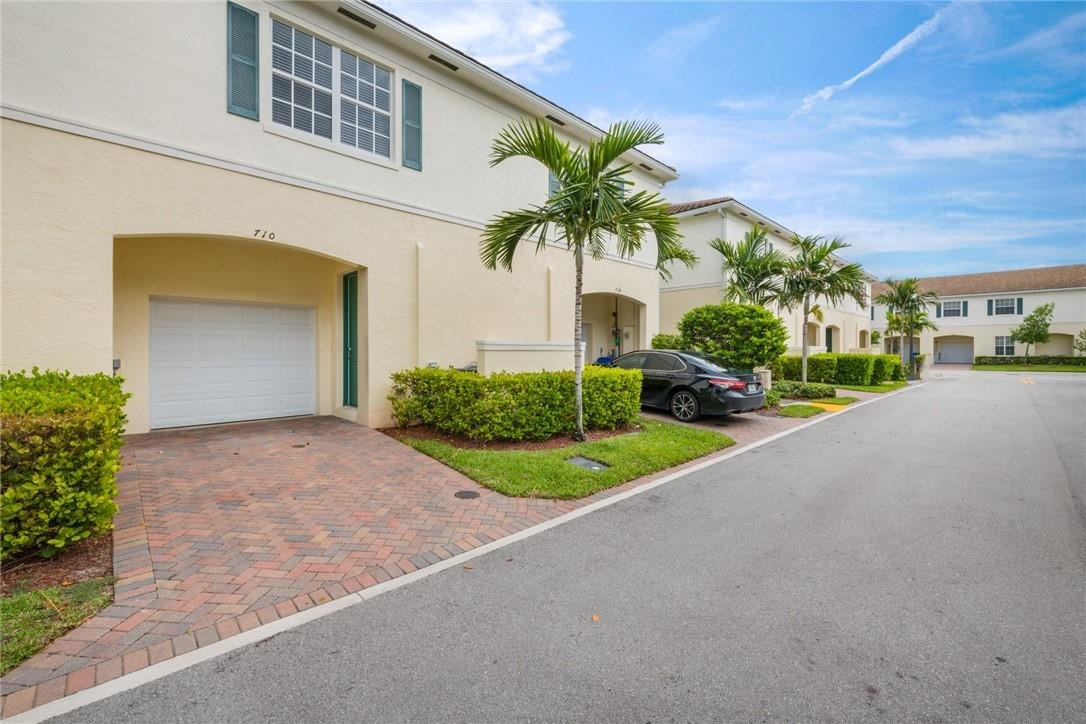 710 Southwest 1st Way Pompano Beach, FL 33060 - Photo 37 of 38 a front view of a house with a yard and a garage