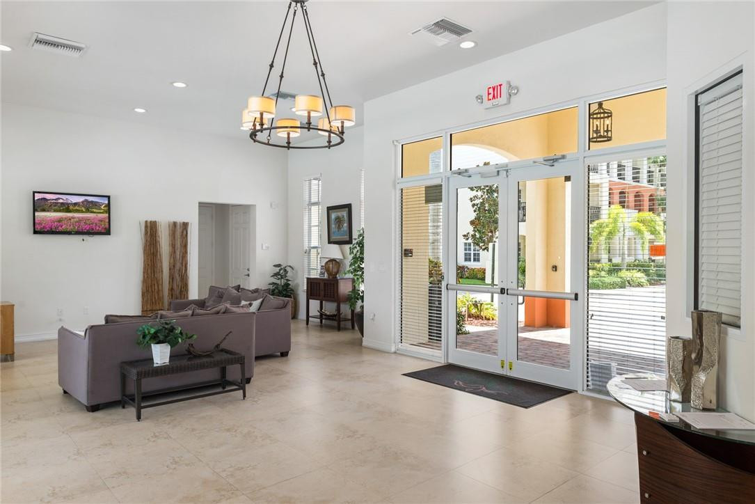 710 Southwest 1st Way Pompano Beach, FL 33060 - Photo 5 of 38 a living room with furniture a chandelier and a large window