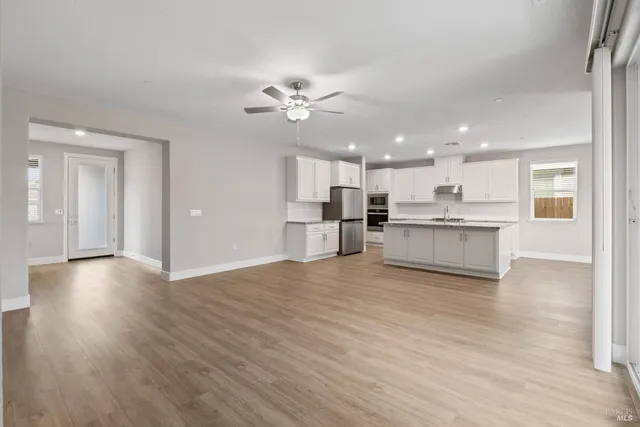 a view of a kitchen with a dishwasher cabinets and wooden floor