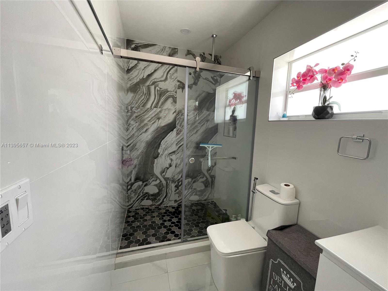 685 East 9th Lane Hialeah, FL 33010 - Photo 34 of 47 a bathroom with a toilet sink and shower curtain