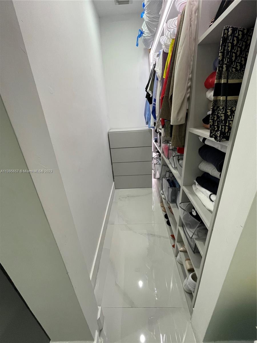 685 East 9th Lane Hialeah, FL 33010 - Photo 39 of 47 a view of walk in closet with clothes and shoes