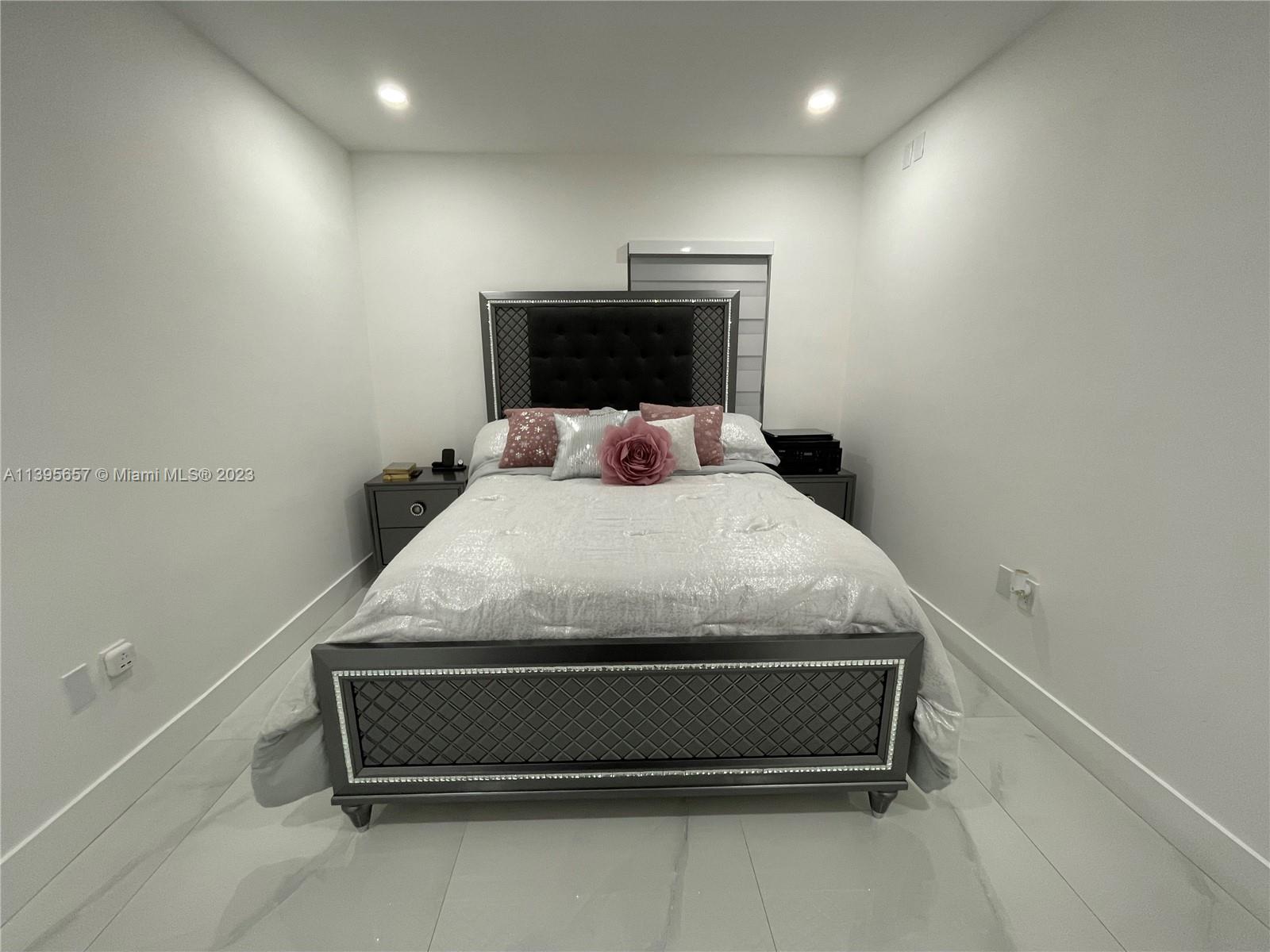 685 East 9th Lane Hialeah, FL 33010 - Photo 41 of 47 a bedroom with a bed and a night stand