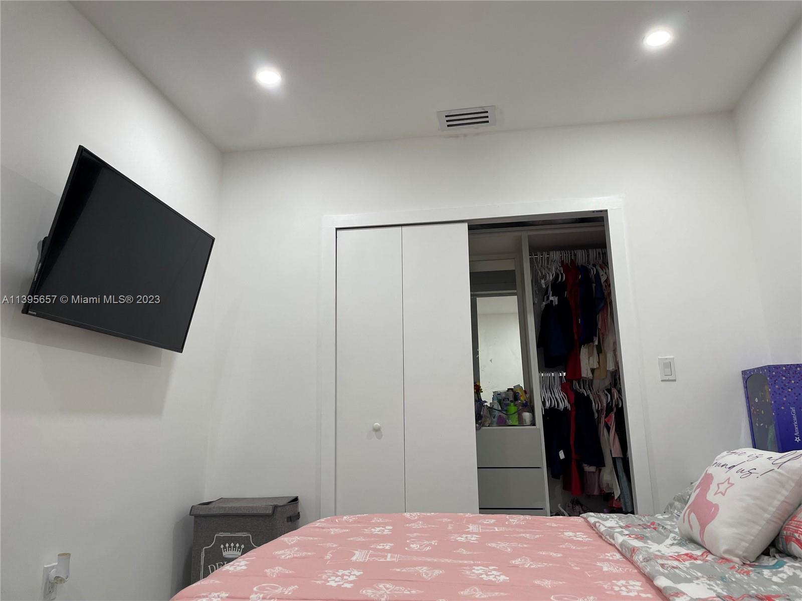 685 East 9th Lane Hialeah, FL 33010 - Photo 43 of 47 a bedroom with a bed and a flat screen tv