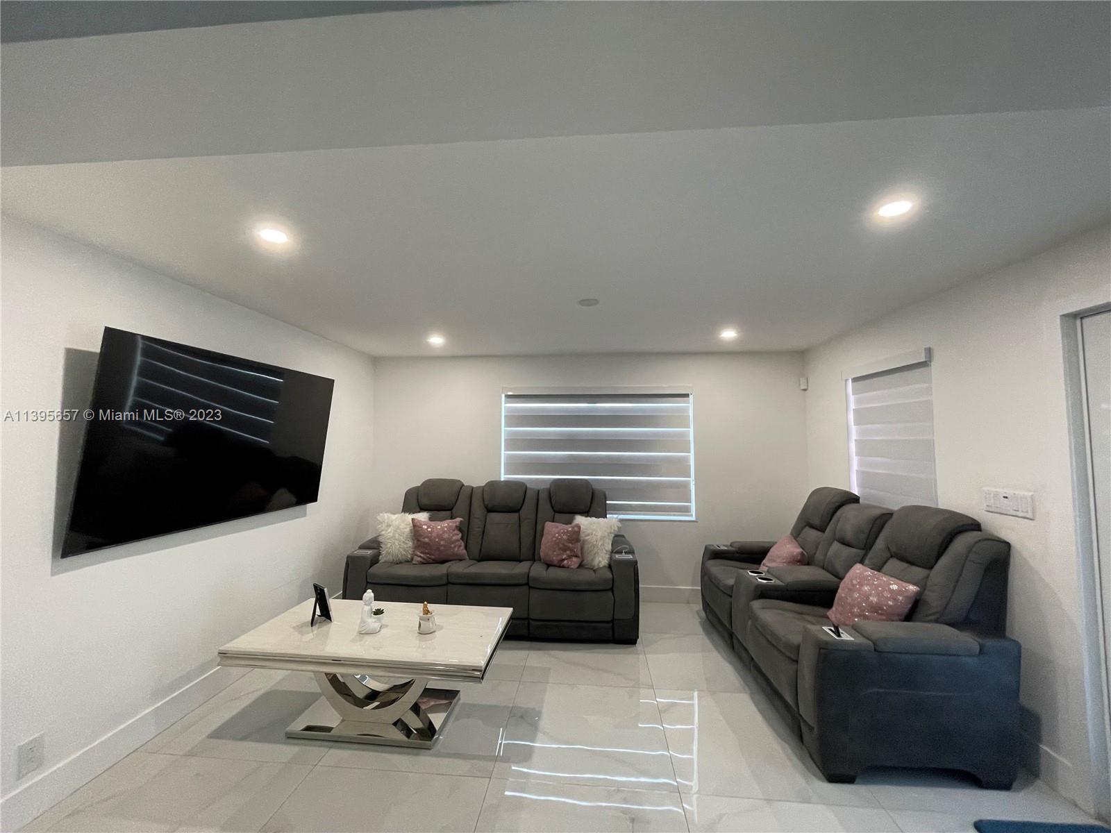 685 East 9th Lane Hialeah, FL 33010 - Photo 47 of 47 a living room with furniture and a flat screen tv