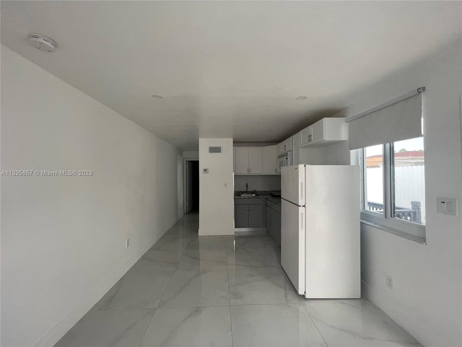 685 East 9th Lane Hialeah, FL 33010 - Photo 9 of 47 a view of a kitchen with a refrigerator cabinets and a window