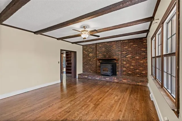 wooden floor in an empty room with a fireplace
