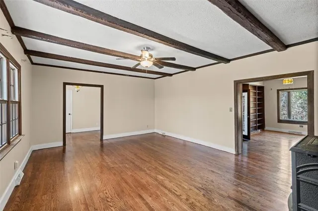 wooden floor in an empty room with a window