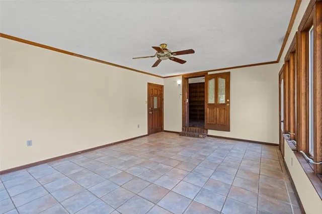 a large kitchen with cabinets and wooden floor