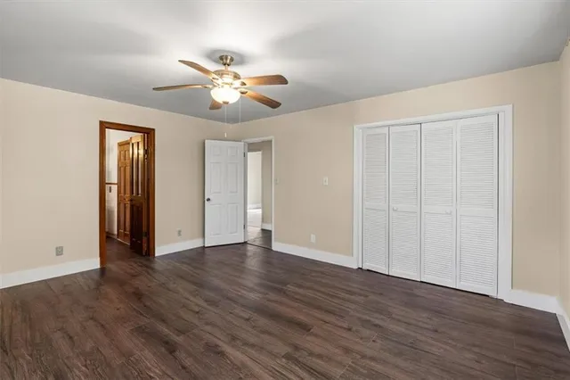a spacious bathroom with a sink a toilet and a mirror