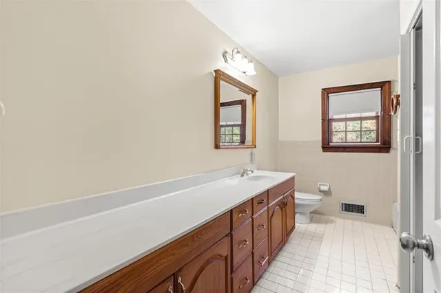 a bathroom with a sink a toilet and bathtub