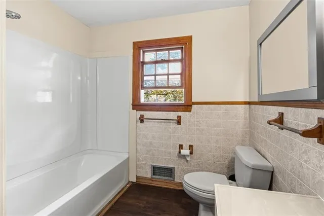 a bathroom with a bath tub and shower