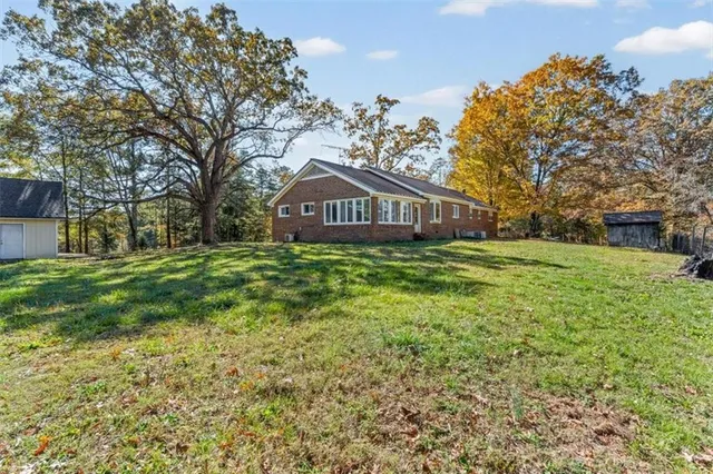 a view of backyard with deck and garden