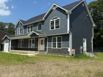 a front view of a house with a garden