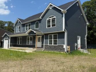a front view of a house with a garden