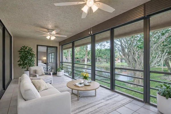 a living room with couch and a large window with outer view