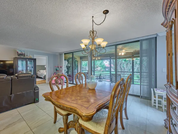 a view of a dining room with furniture wooden floor and chandelier