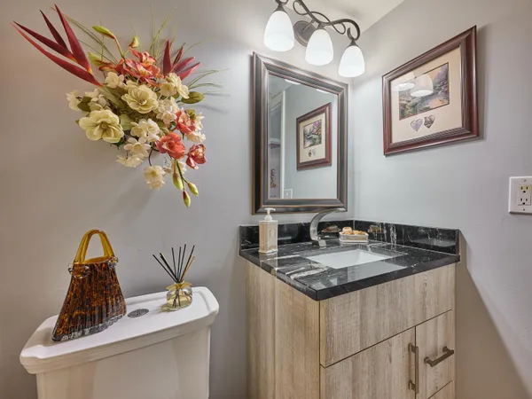 a bathroom with a sink a vanity and a mirror