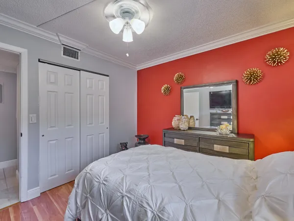 a bedroom with a large bed and a chandelier