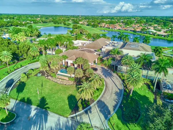 an aerial view of residential houses with outdoor space and trees