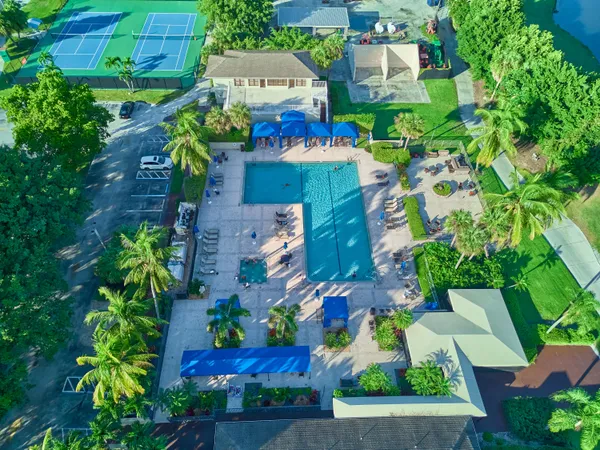 an aerial view of residential houses with outdoor space and street view