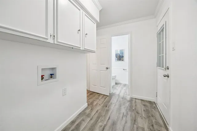 a view of empty room with wooden floor