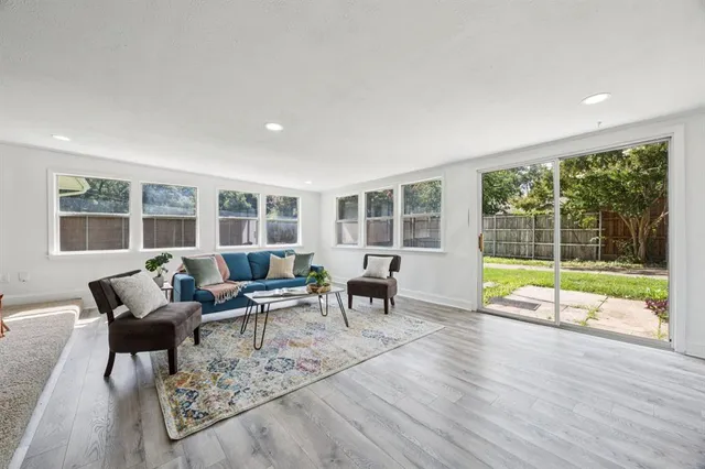 a living room with furniture and large windows
