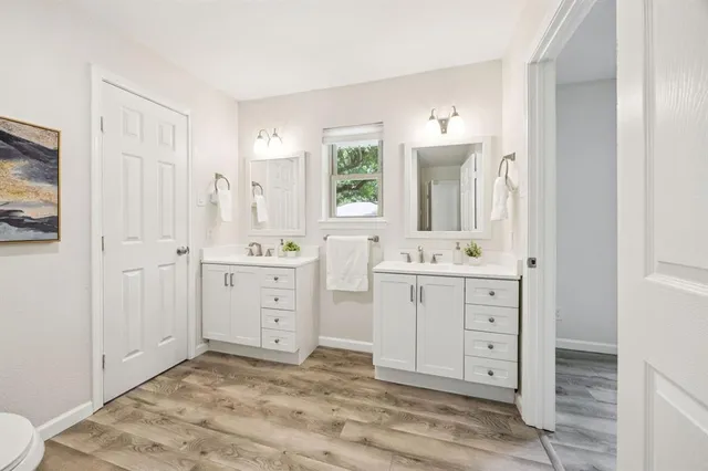 a bathroom with a sink a mirror and a vanity