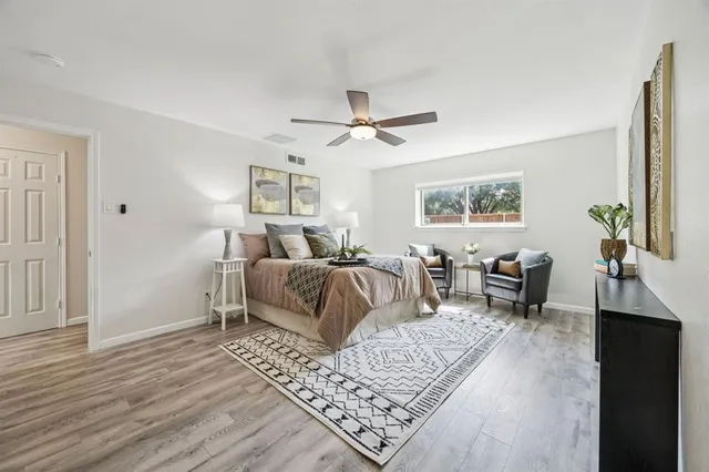 a bedroom with furniture and a rug