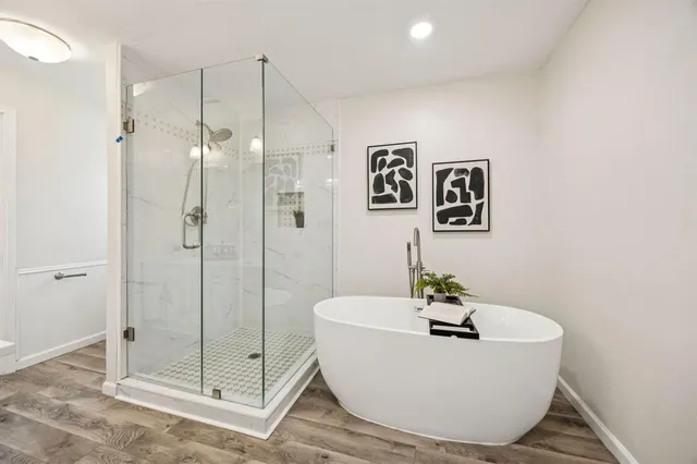 a white bath tub sitting next to a bathroom