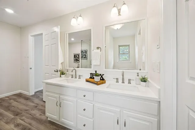 a bathroom with a sink double vanity and a mirror