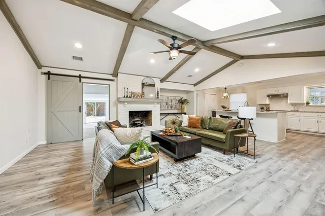 a living room with furniture fireplace and a wooden floor