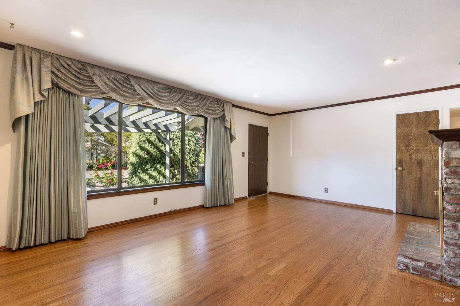 2236 West Hearn Avenue Santa Rosa, CA 95407 - Photo 12 of 56 a view of an empty room with wooden floor and a window