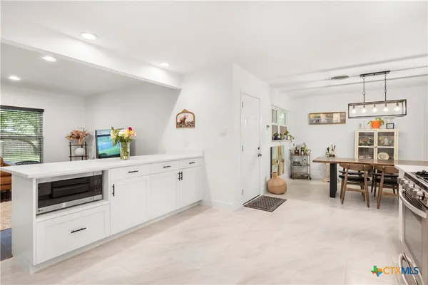 a kitchen with furniture and a stove