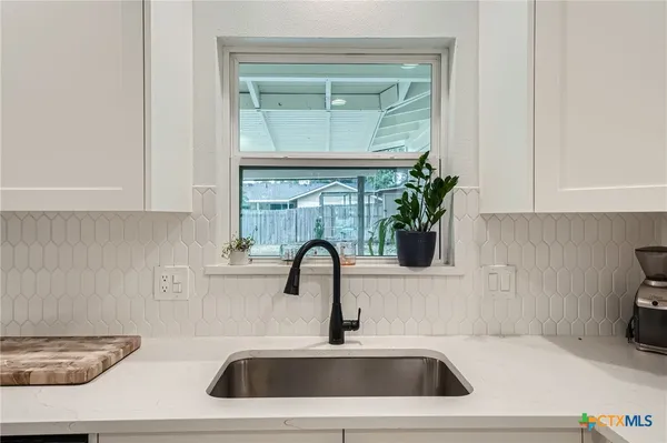 a kitchen with a sink and a microwave