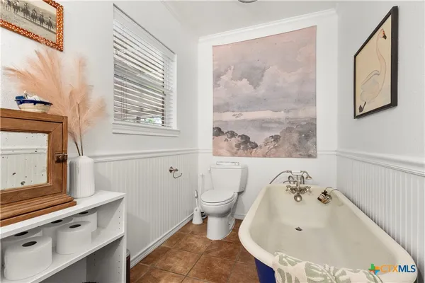 a bathroom with a bathtub and a window