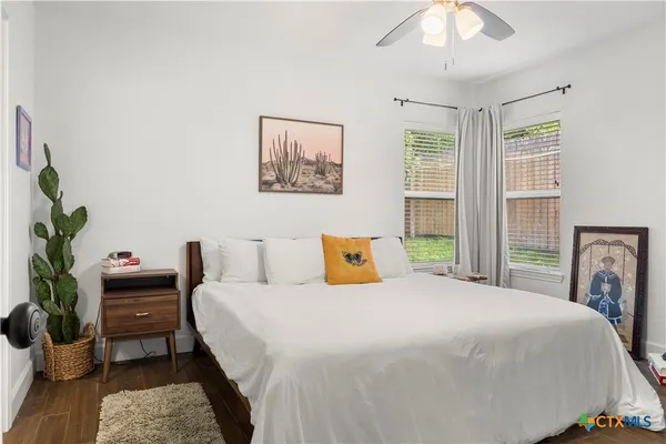 a bedroom with a bed table and a window