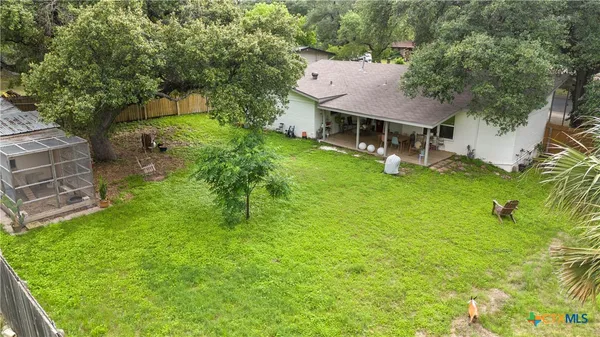 a backyard of a house with table and chairs