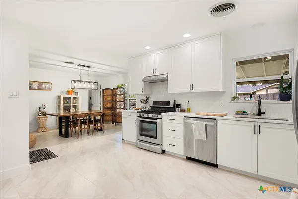 a kitchen with sink cabinets and microwave