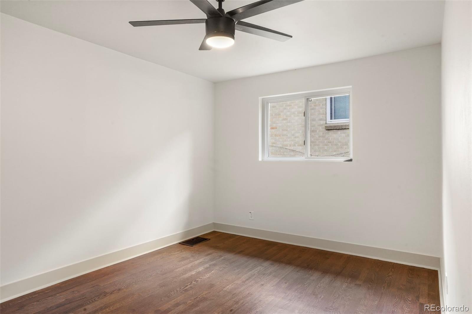 809 Forest Street Denver, CO 80220 - Photo 11 of 15 an empty room with a window and a fan