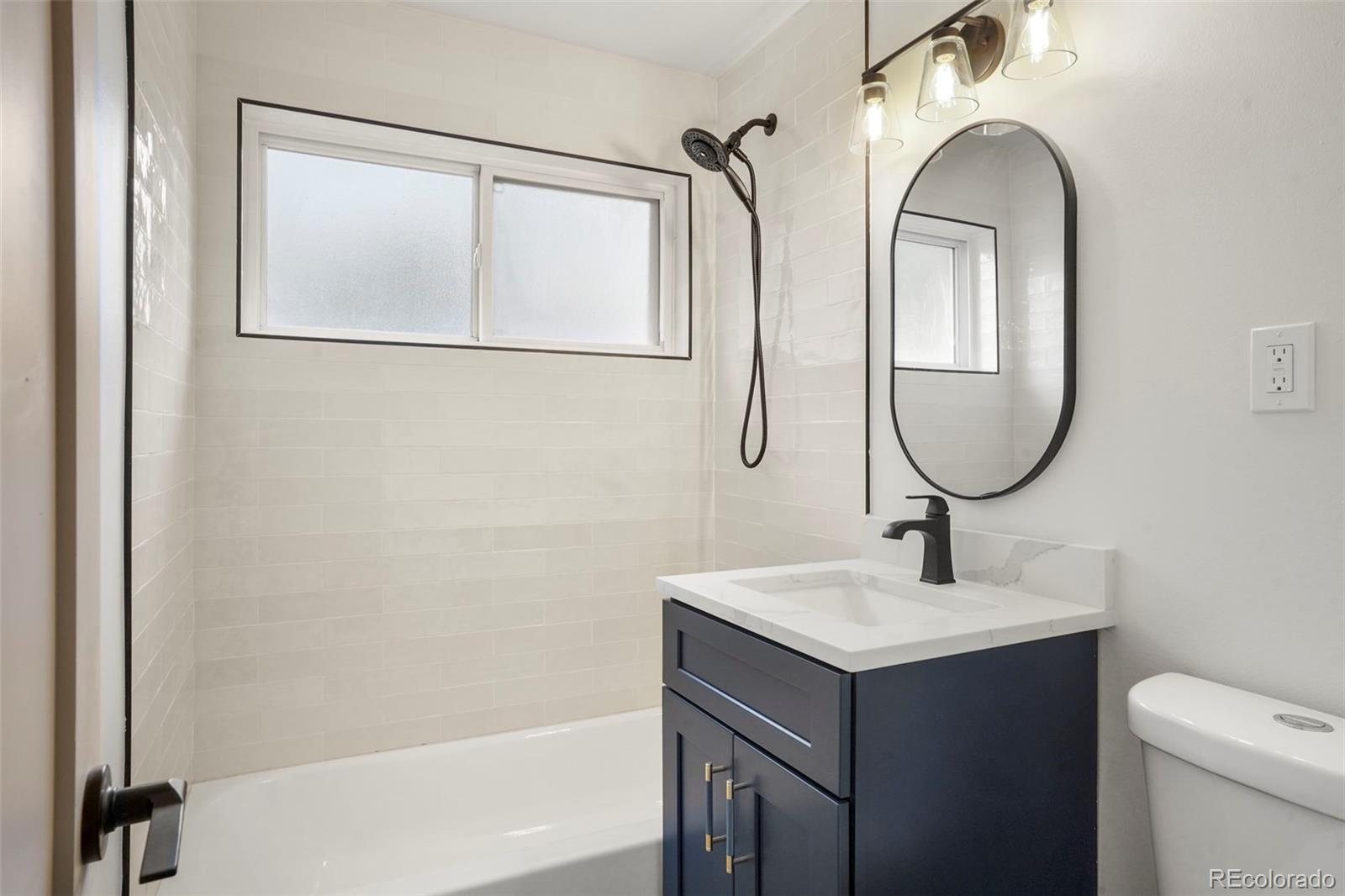 809 Forest Street Denver, CO 80220 - Photo 9 of 15 a bathroom with a sink and a mirror