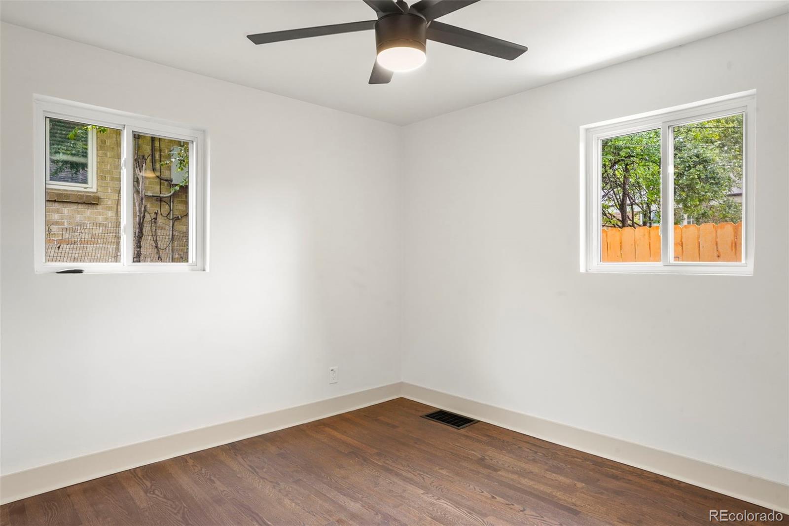 809 Forest Street Denver, CO 80220 - Photo 10 of 15 an empty room with a window and a ceiling fan