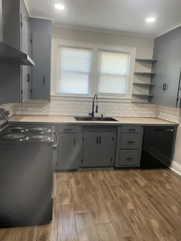 a kitchen with stainless steel appliances granite countertop a sink and cabinets