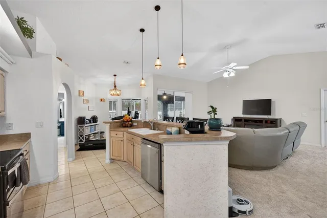 a bedroom with a bed and a flat tv screen on dresser
