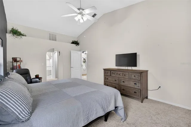 a bedroom with a bed a desk and chair