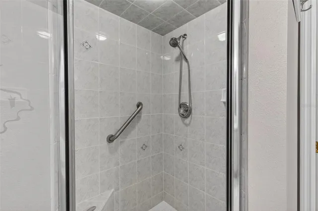 a bedroom with a bed and a flat tv screen on dresser