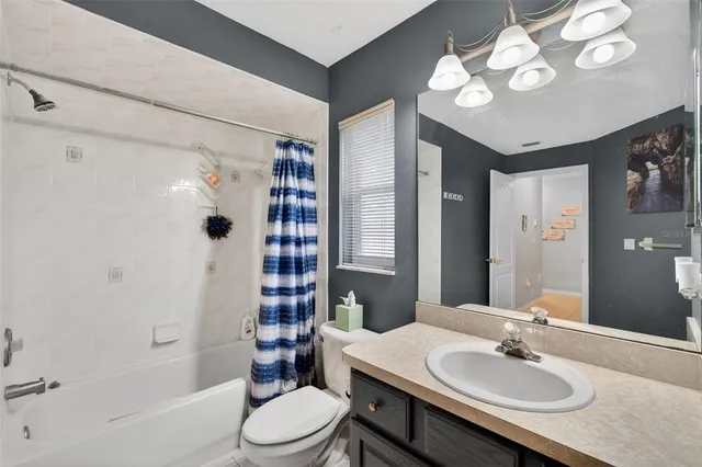 a living room with patio furniture and a floor to ceiling window